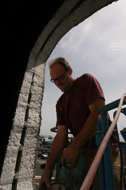 Bob Penny helps The RE Store install windows in it's Bellingham facility