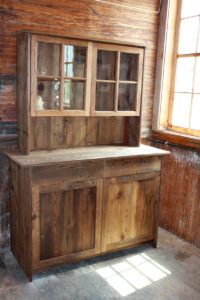 Tombstone cabinet with attached upper and wavy glass doors