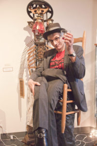 Eberhard wears a chair at te gallery opening