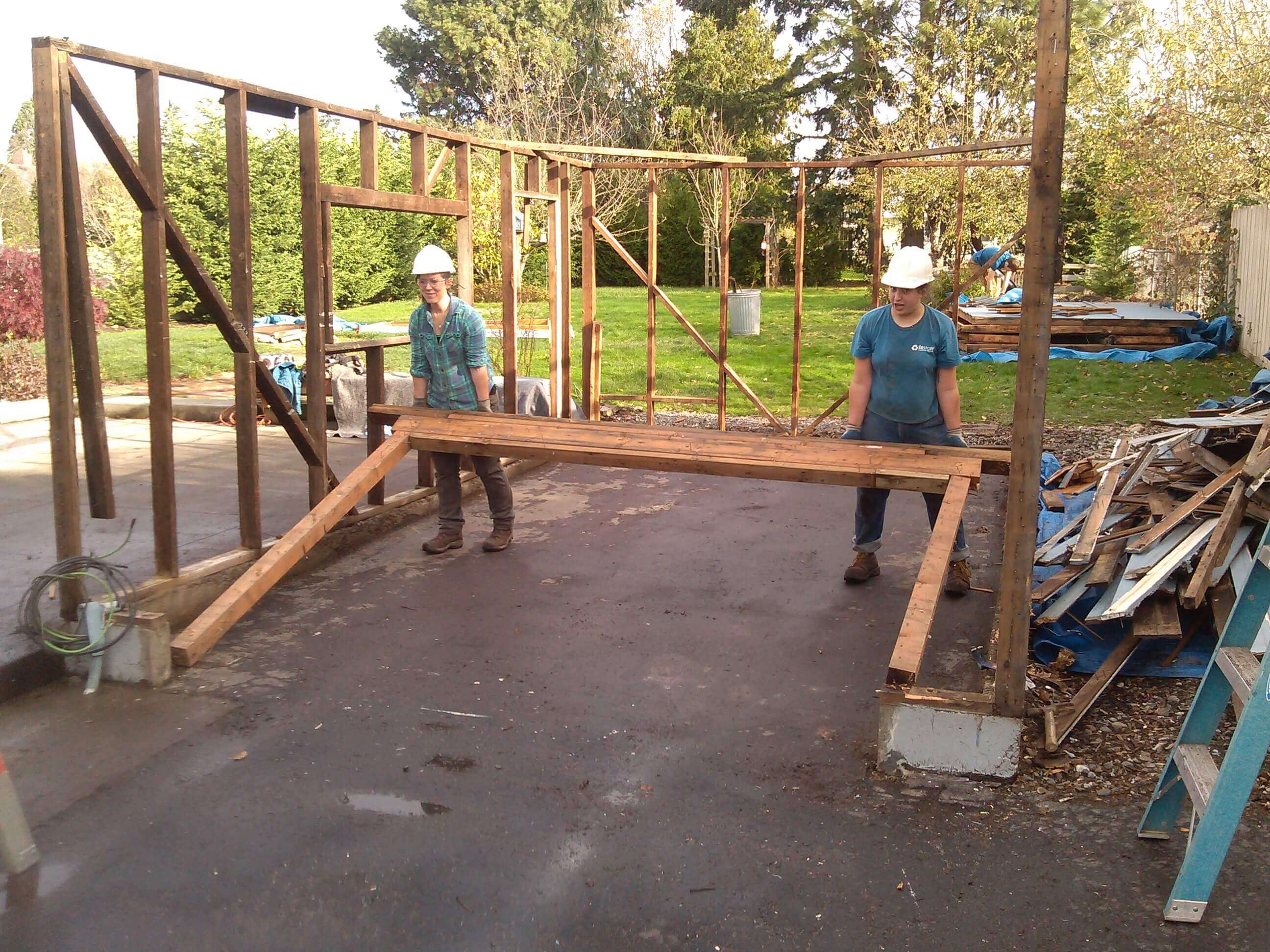 Ladies of the field crew deconstructing a garage