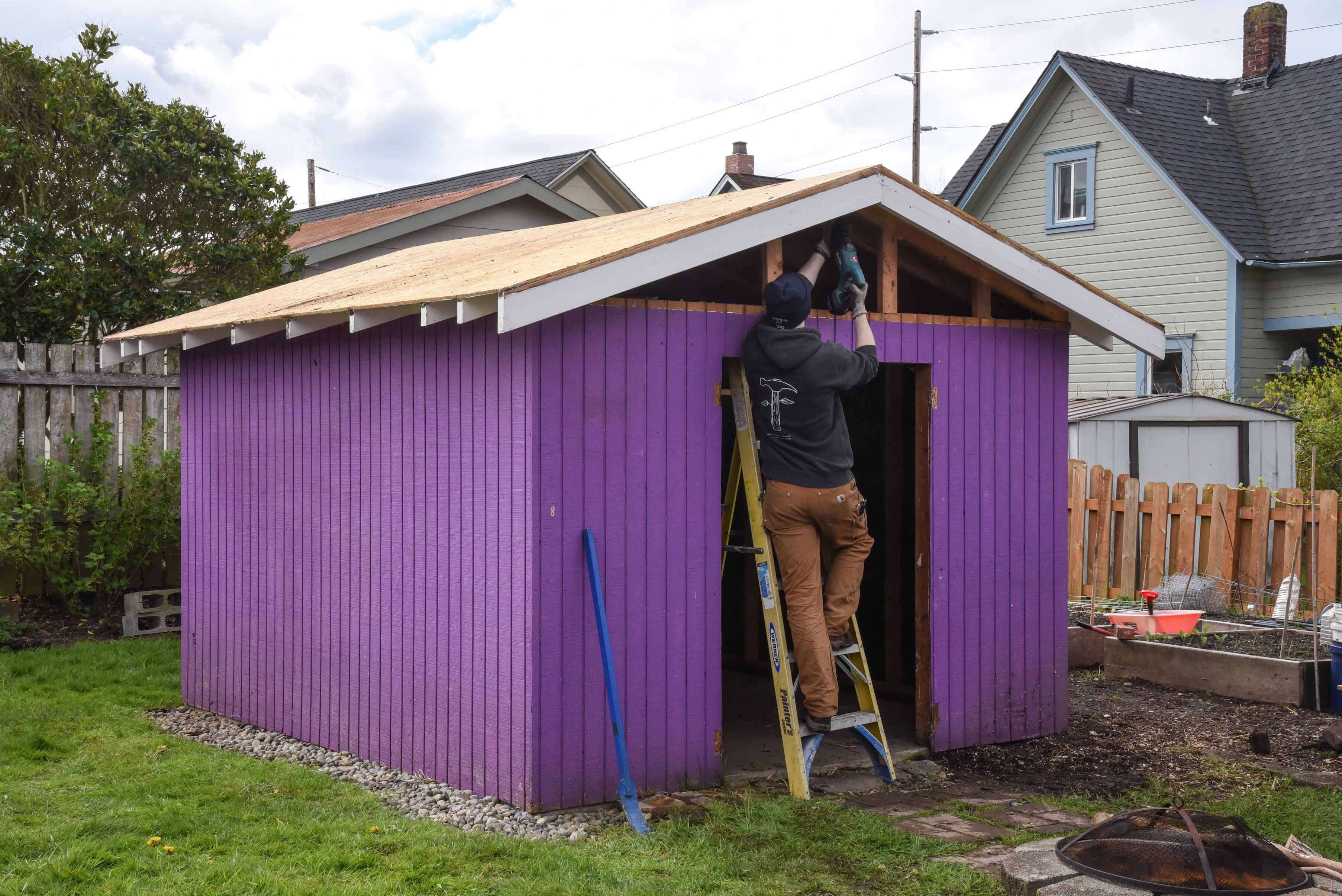 Salvage Crew workers deconstructing a shed piece by piece